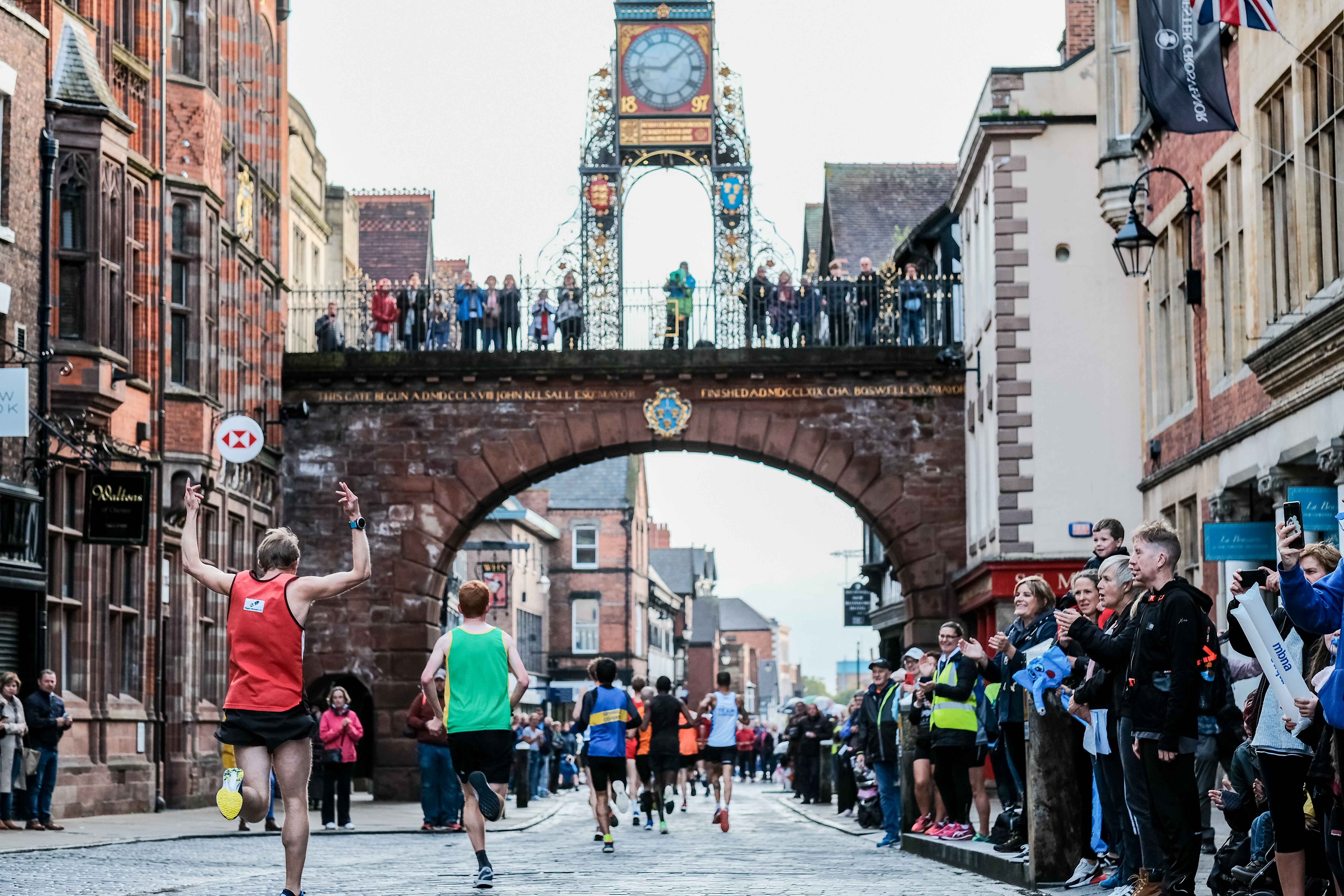Chester Marathon runners passing beneath Eastgate Clock.