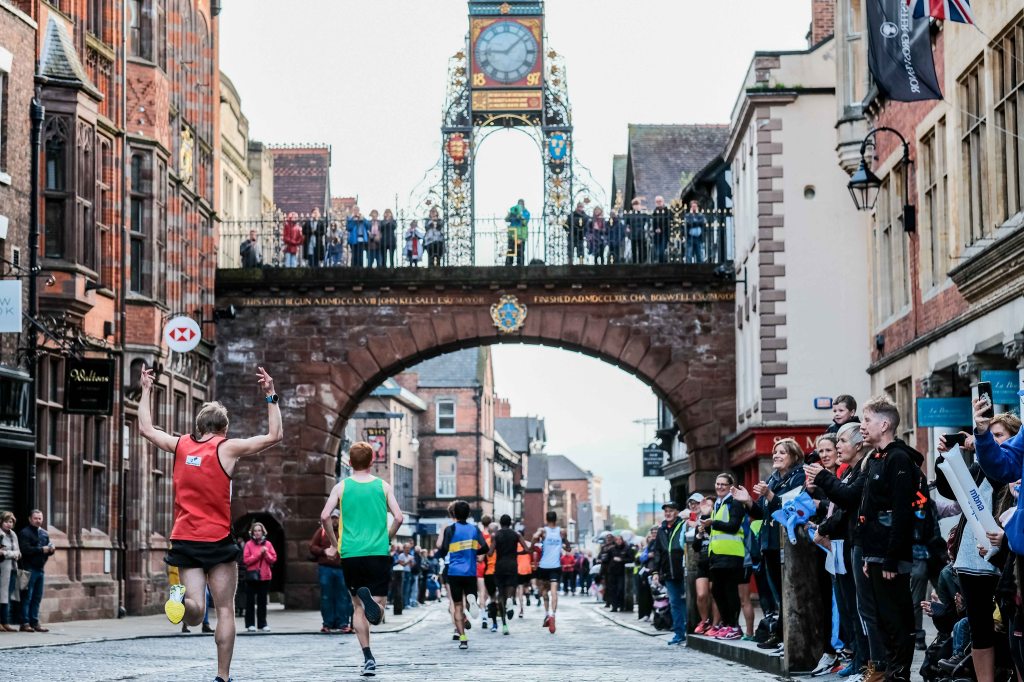 Chester Marathon runners passing beneath Eastgate Clock.