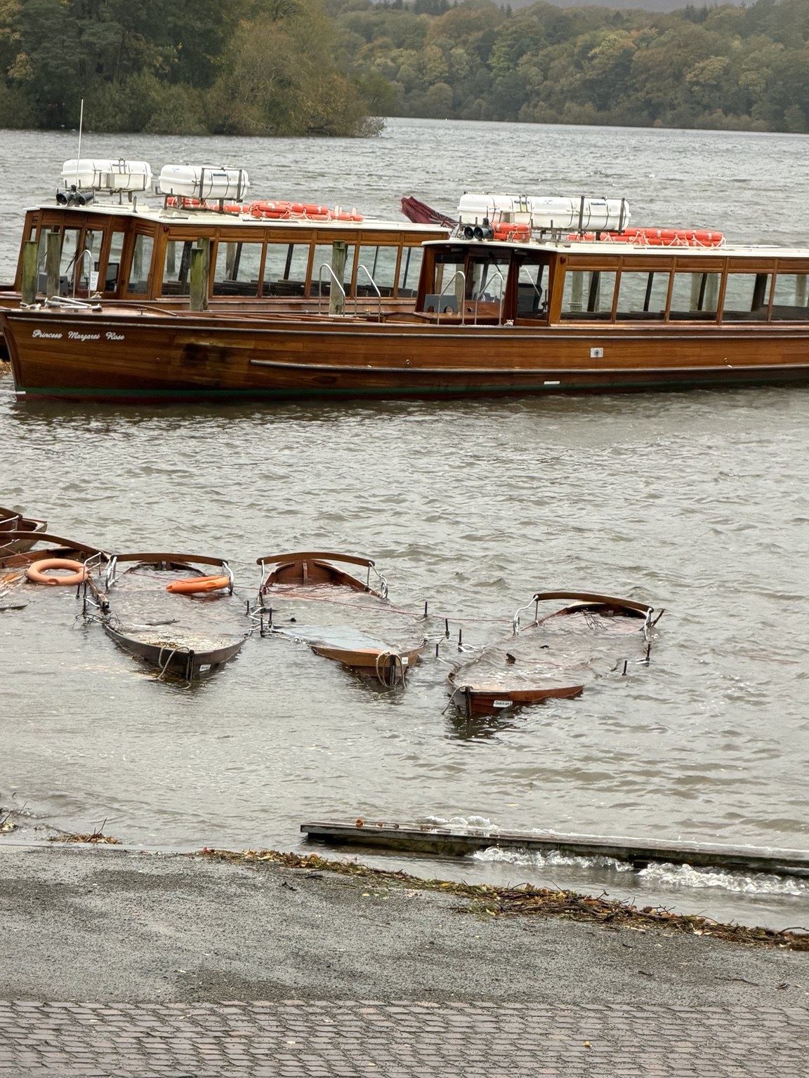 Boats on a Lake District lake in rough autumn weather during Storm Boelo