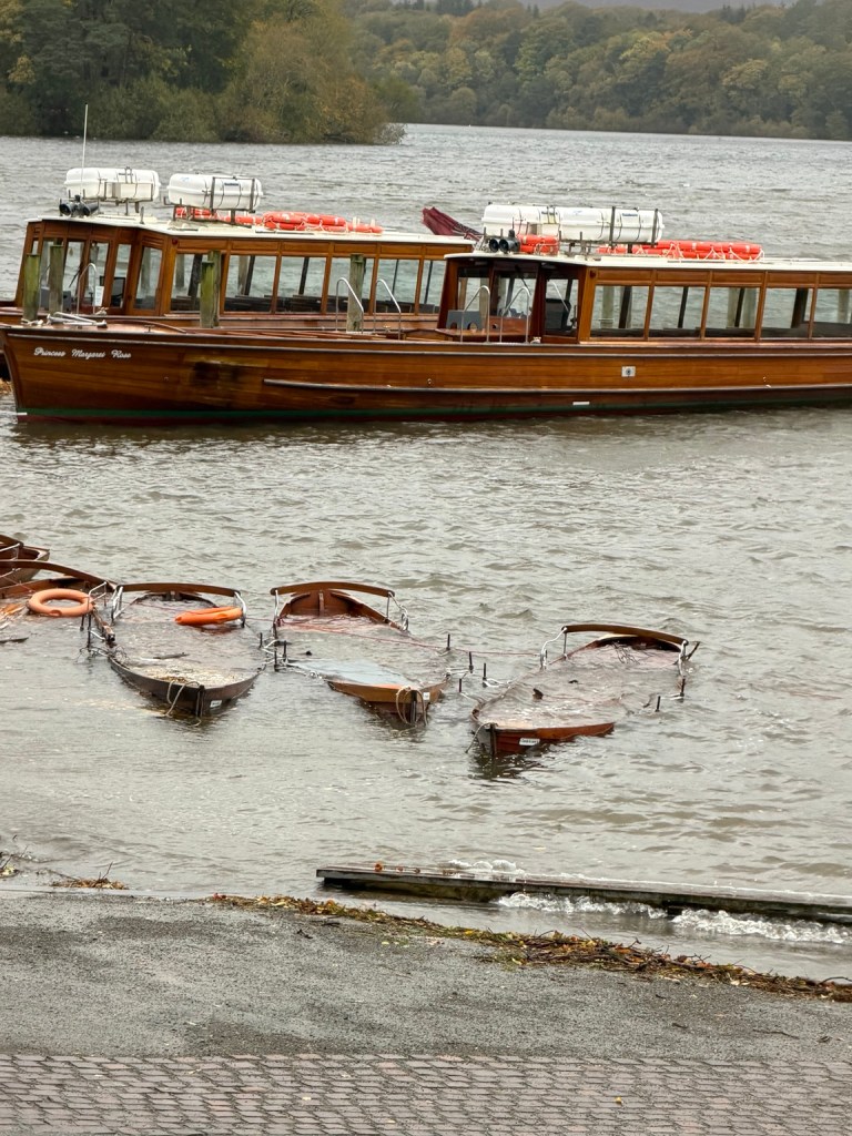 Boats on a Lake District lake in rough autumn weather during Storm Boelo